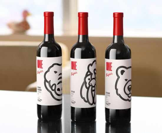 Three wine bottles on a table with black & white graphics on the label