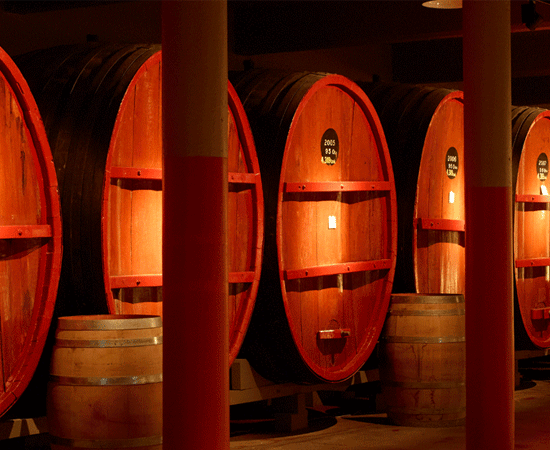 Warmly lit large St Henri wine vats