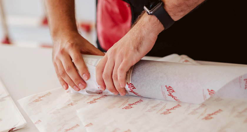 Grange bottle being wrapped in tissue paper