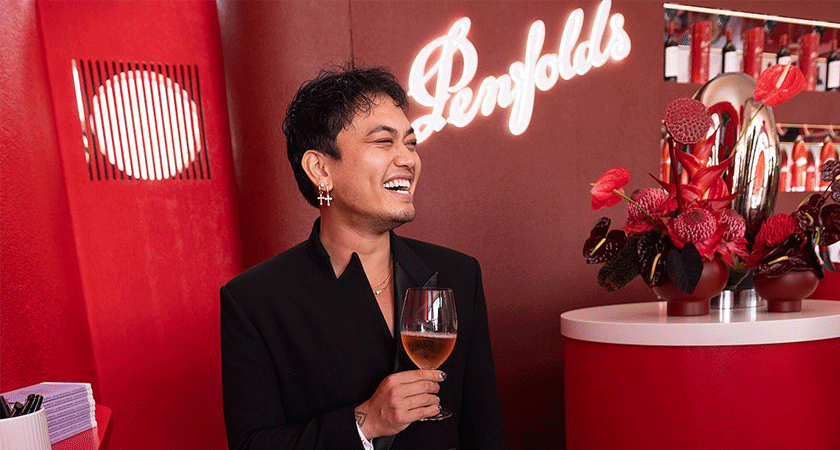 Guest poses with a glass of wine