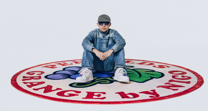 NIGO sitting on Penfolds Grange x NIGO limited edition rug