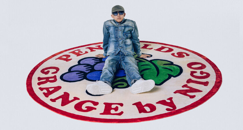 NIGO sitting on the Limited Edition Silk Rug